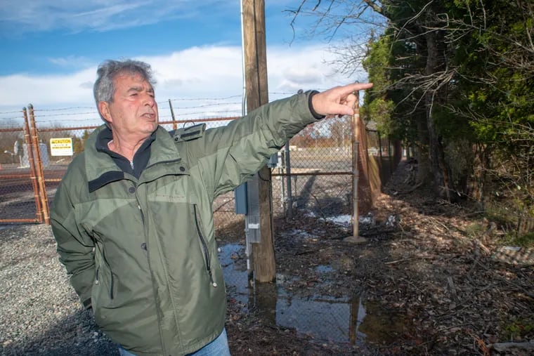At the border of his property in West Rockhil Township, Tom Cuce points to his home. He and his wife, Rose Merrigan, live next door to the proposed site of a compressor station for the Adelphia Gateway natural gas pipeline.