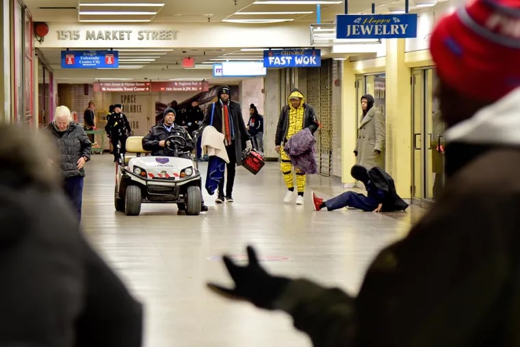 SEPTA Transit Police arrive after midnight February 19, 2019 to clear out the large number of homeless people who routinely stay in Suburban Station, before locking the doors for the night.