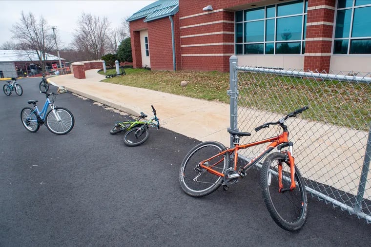 Student bicycles rest on the sidewalk after their school was closed for the day because of a possible coronavirus threat Friday, March 06, 2020 at Titus Elementary School in Warrington, Pennsylvania. Five Central Bucks School District schools were closed as a precaution against coronavirus and reopened Monday.