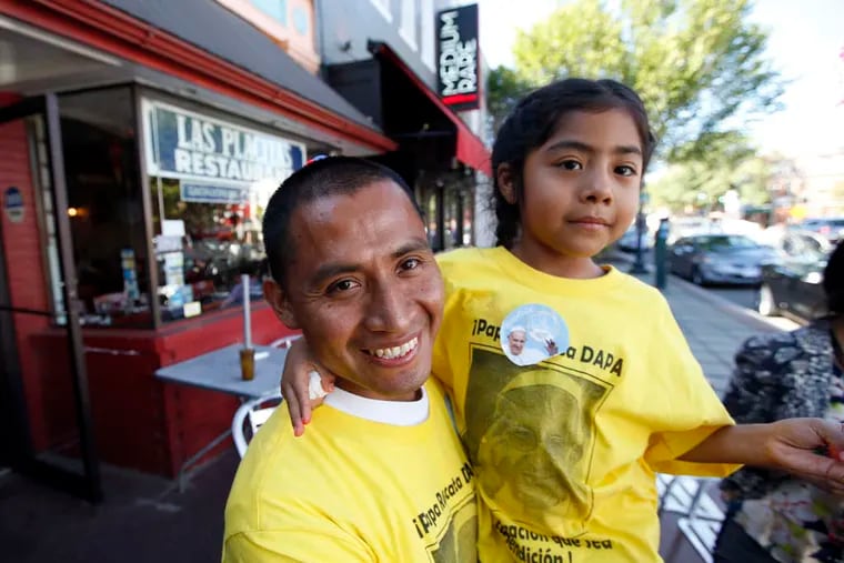 Raul Cruz, from South Gate, Calif., holds daughter Sophie, 5, in Washington.