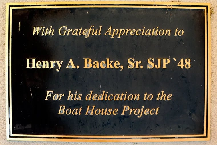 Plaque on the St. Joe's Prep boathouse honors Henry A. Backe, Sr. Class 1948, on the Schuylkill River May 17, 2013, the first day of Stotesbury Cup HS Regatta. ( TOM GRALISH / Staff Photographer )