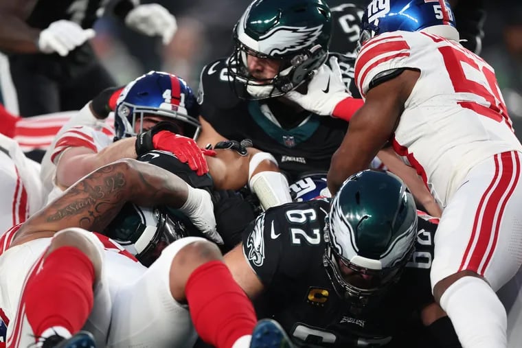 Eagles center Jason Kelce (right) leads the way on a “tush push” play as the Eagles face the Giants at Lincoln Financial Field in Philadelphia, Pa. on Monday, Dec. 25, 2023.