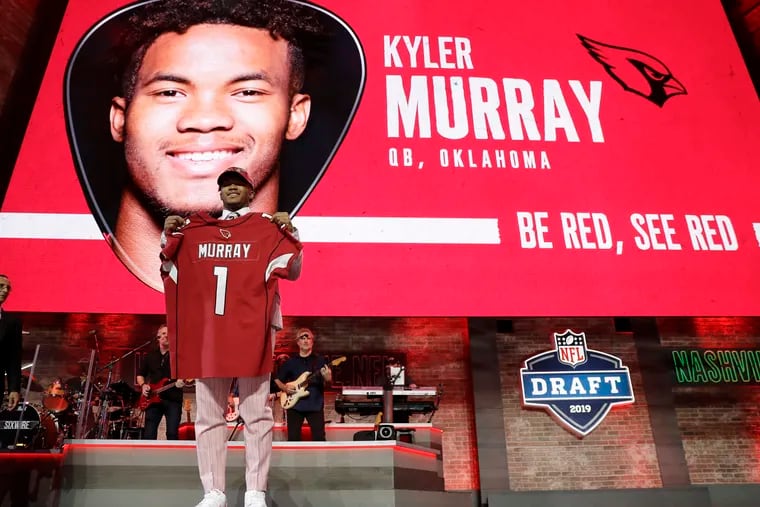Kyler Murray shows off an Arizona Cardinals jersey after being drafted first overall.