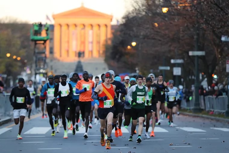 The elite runners race down the Benjamin Franklin Parkway at the start of the Philadelphia Marathon in 2022.