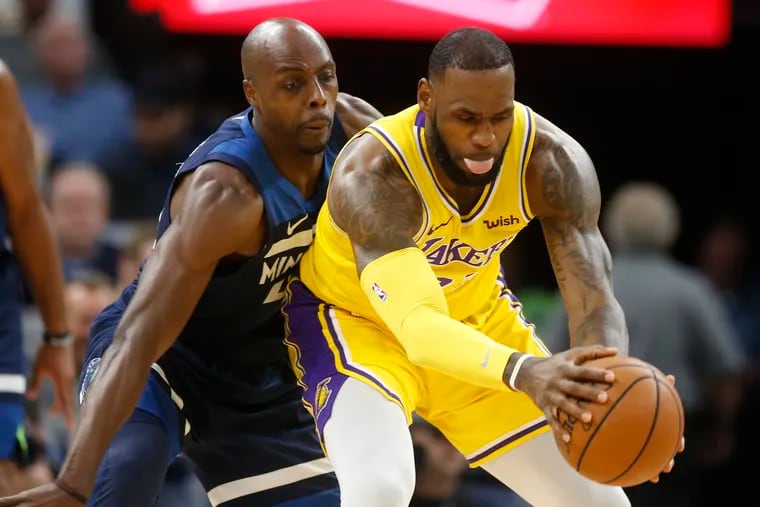 Anthony Tolliver, playing for the Minnesota Timberwolves in 2018, guards the Lakers' LeBron James. The Sixers will be Tolliver's 11 NBA team.