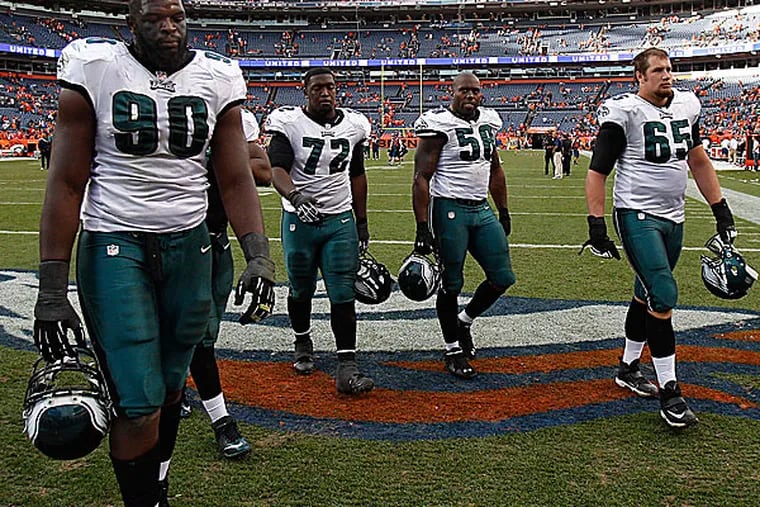 Eagles players leave the field after the loss to the Broncos. (David Maialetti/Staff Photographer)