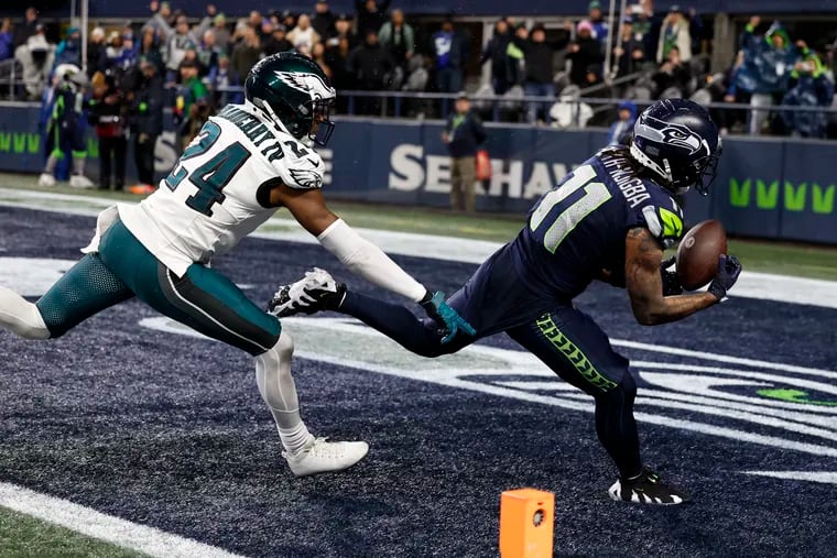 Seahawks wide receiver Jaxon Smith-Njigba catches the decisive touchdown pass as Eagles cornerback James Bradberry defends late in the fourth quarter Monday night.