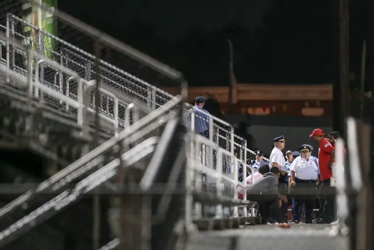 Police check the bleachers after two people were hurt in gunfire at the Marcus Foster Memorial Stadium in the Nicetown-Tioga neighborhood while Simon Gratz was playing Imhotep in a football game Friday night,  September 20, 2019. Acting Police Commissioner Christine Coulter is in the lower right.
