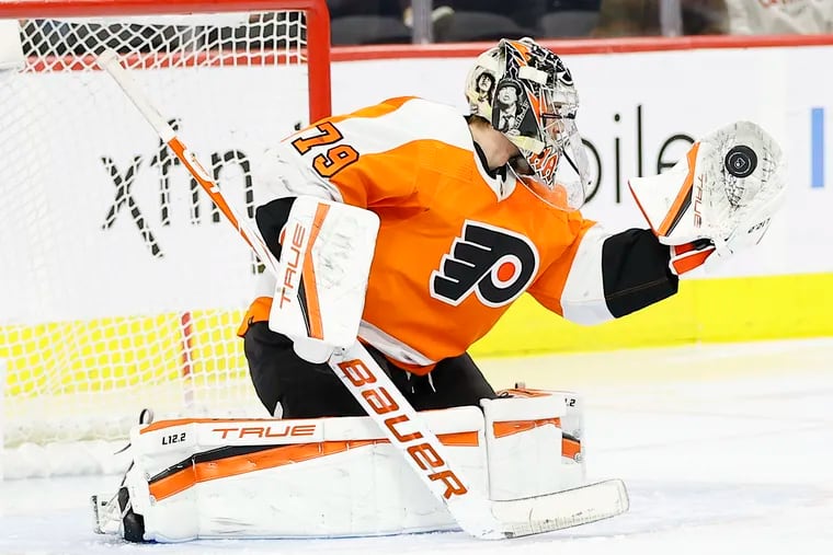 Flyers goaltender Carter Hart catches the puck during the second period against the Minnesota Wild.