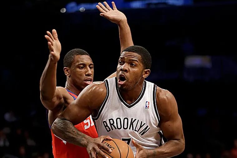 The Nets' Joe Johnson looks for the basket past the 76ers' Thaddeus Young during the first half. (Seth Wenig/AP)