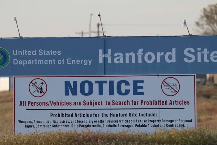 FILE: In this file photo from Tuesday, May 9, 2017, signs are posted by the Hanford Nuclear Reservation in Richland, Wash. State officials this week filed their objections to a Trump administration plan to reclassify millions of gallons of waste stored in underground tanks at Hanford Nuclear Reservation.  (AP Photo/Manuel Valdes)
