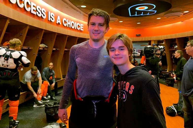JVK and JVR: Johnny Van Kemp, 15, who is battling leukemia, posing Monday with left winger James van Riemsdyk (left) in the Flyers' locker room in Voorhees.