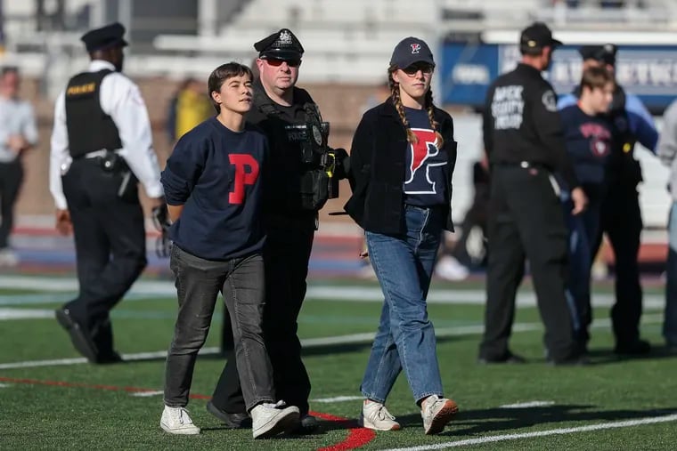 Protesters with Fossil Free Penn were arrested after they took over the field during halftime of a football game between Penn and Yale at Franklin Field in Philadelphia on Oct. 22, 2022.