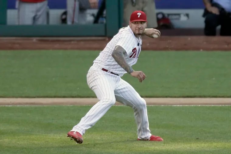 Phillies pitcher Vince Velasquez throws the ball left-handed after being hit in his right elbow by a line drive.