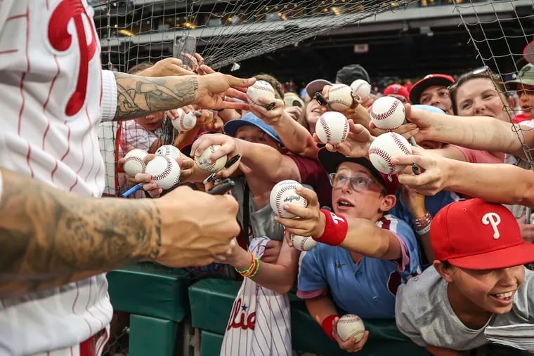 Fans clamor for an autograph from Phillies right fielder Nick Castellanos before the start of a game against the Los Angeles Angels at Citizens Bank Park.