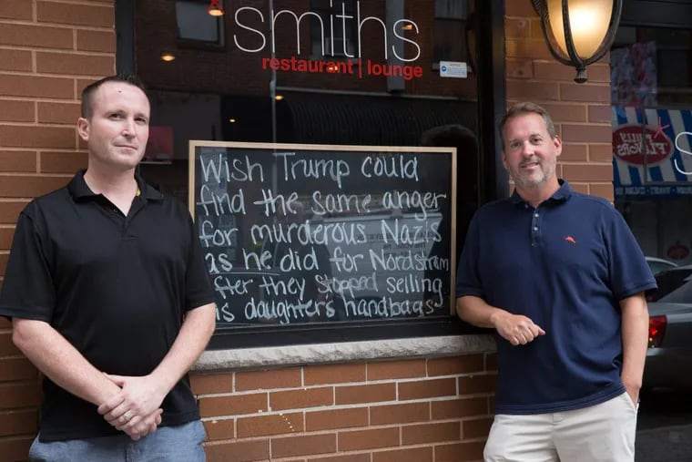 General manager John Barry and owner Brendan Smith (right) at Smith’s  Restaurant in Center City, with the controversial chalkboard.