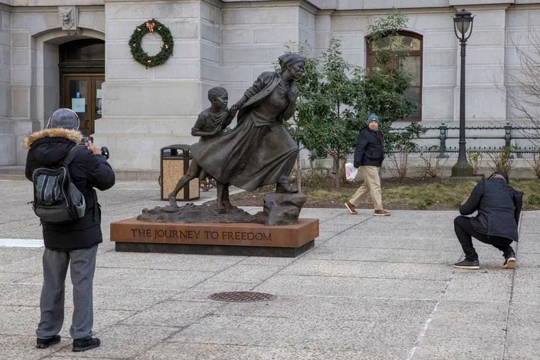 People stop to visit the statue of Harriet Tubman unveiled yesterday on the north side of Philadelphia City Hall. Photograph taken on Wednesday afternoon, January 12, 2022.