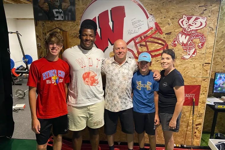 Wisconsin's Keeanu Benton pictured with his high school wrestling coach, Mark Mullen, and his family.