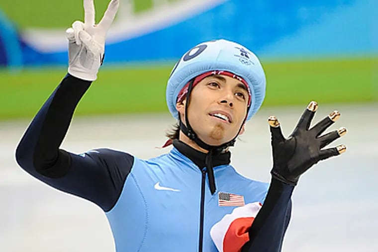 Apolo Ohno holds up seven fingers to signify his seven medals, the most in U.S. Winter Olympics history. (Clem Murray/Staff Photographer)