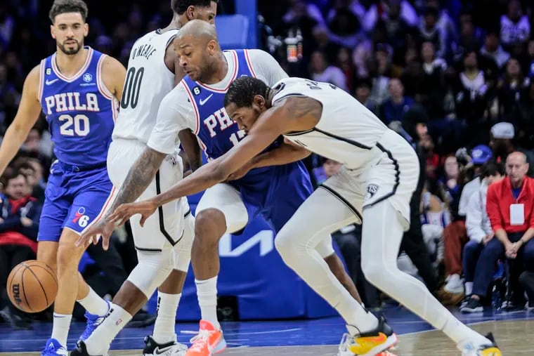 The Sixers' P.J. Tucker knocks the ball away from Brooklyn's Kevin Durant during the second quarter Tuesday night.