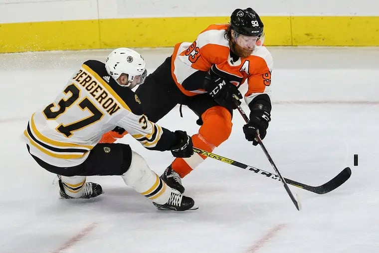 Flyers right winger Jake Voracek (right) and Boston's Patrice Bergeron battle for the puck during their March 10 matchup at the Wells Fargo Center, the last game the teams played before the season was halted because of the coronavirus. The Bruins and Flyers are strong Eastern Conference contenders if the season restarts.