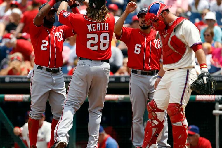 Jayson Werth celebrates his three-run first inning home run with teammates as Phillies catcher Cameron Rupp kicks the dirt.
