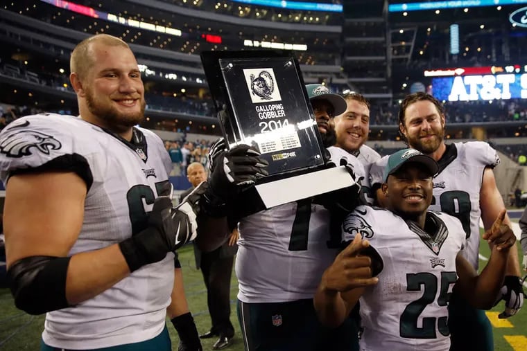 Eagles' Lane Johnson, Jason Peters, LeSean McCoy, Andrew Gardner and Evan Mathis celebrates with the Galloping Gobbler award after beating the Dallas Cowboys.  The award is a television award.  ( YONG KIM / Staff Photographer )