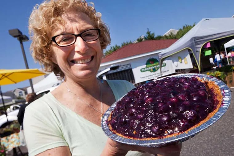 Caroline "Cookie" Till holds her blueberry pie, available at Steve & Cookie's in Margate. ( DAVID M WARREN / Staff Photographer )