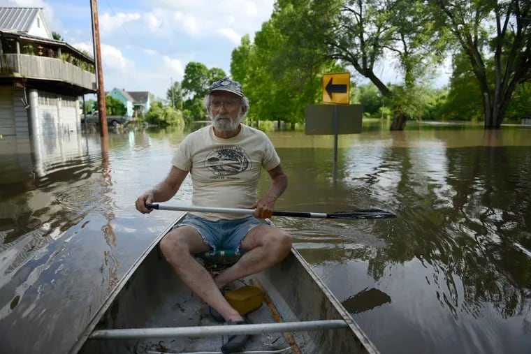 A Missouri resident rows his canoe through floodwaters earlier in the week.(Armond Feffer/Missourian via AP)