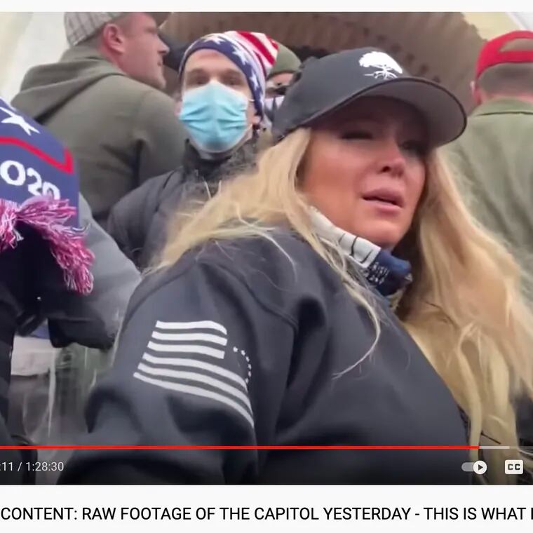 A screenshot of a YouTube video from self-described "conservative news" account Action 8 News shows Stephanie Hazelton participating in the Jan. 6 rioting on the steps of the U.S. Capitol.