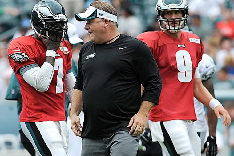 Eagles coach Chip Kelly calls out a play as Michael Vick and Nick Foles line up. (Michael Perez/AP)