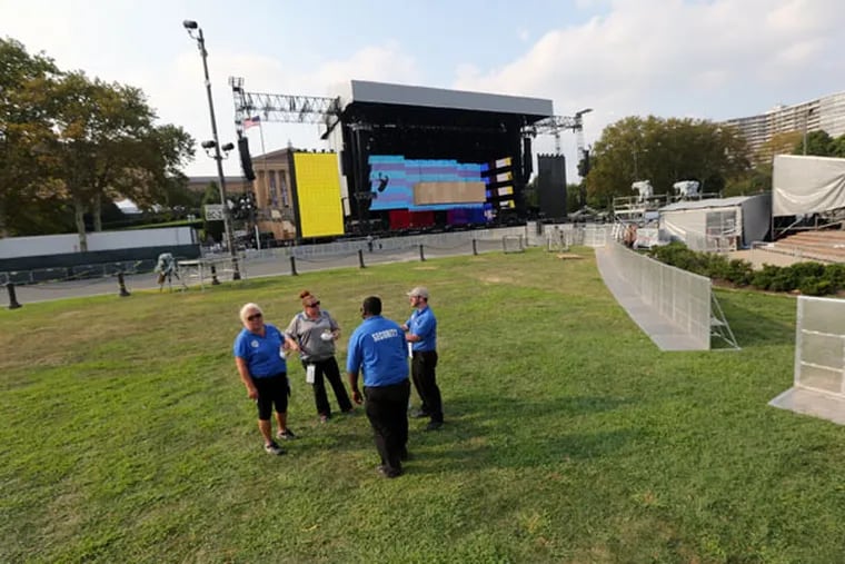 Stagehands and others ready the Parkway for the Made in America festival. (DAVID SWANSON/Staff Photographer)