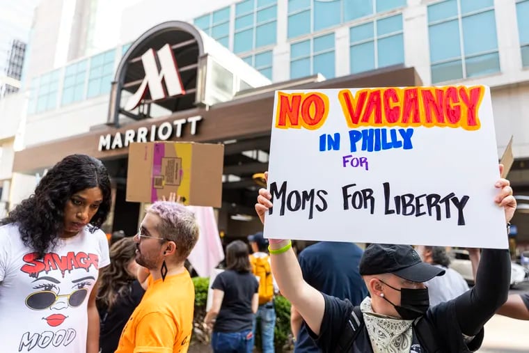 Members of ACT UP Philadelphia and other advocates rallied Friday evening outside the Philadelphia Marriott Downtown, where the national gathering of Moms for Liberty is scheduled to be held June 29 through July 2.