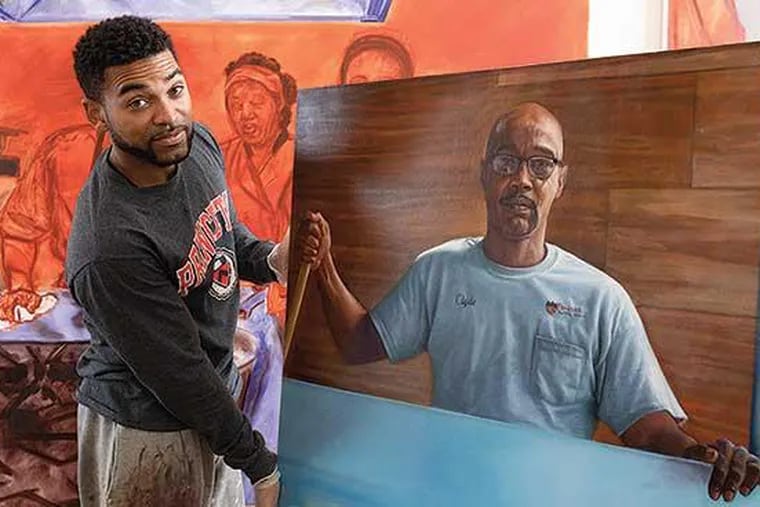 Mario Moore holds a painting he created for Princeton University.