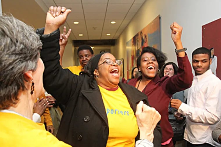 Supporters and staffers of the E.M. Stanton School, including parent Aisha Bey (center), celebrate after hearing their school was one of two the School Reform Commission will not close. CHARLES FOX / Staff Photographer