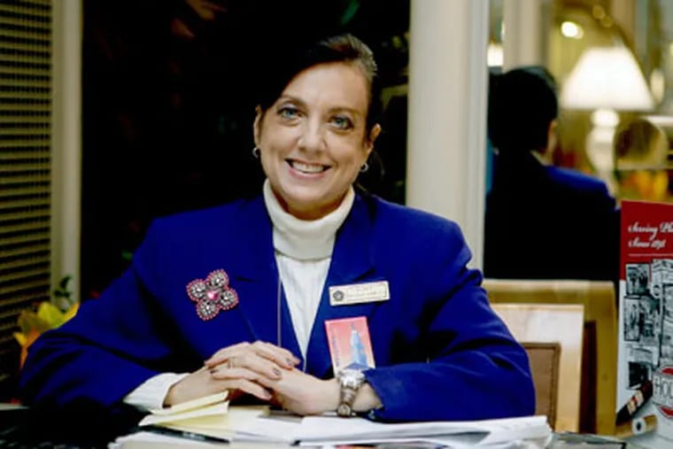 Gale Feinstein poses at her concierge desk at the Omni Hotel. (Akira Suwa / Staff Photographer )