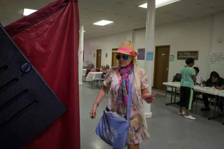 Maryann Masucci prepares to enter the voting booth Tuesday, June 7, 2016, at Prince Memorial A.M.E. Zion Church in Atlantic City.