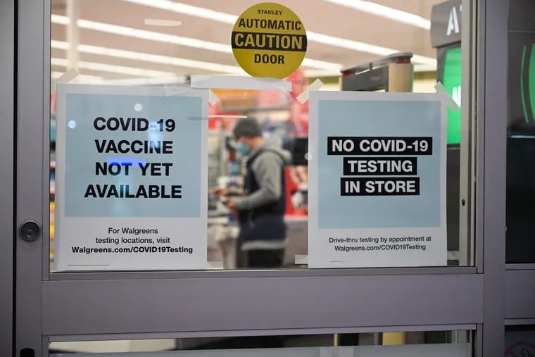 A sign on the entrance to a pharmacy reads "Covid-19 Vaccine Not Yet Available", November 23, 2020 in Burbank, California.
