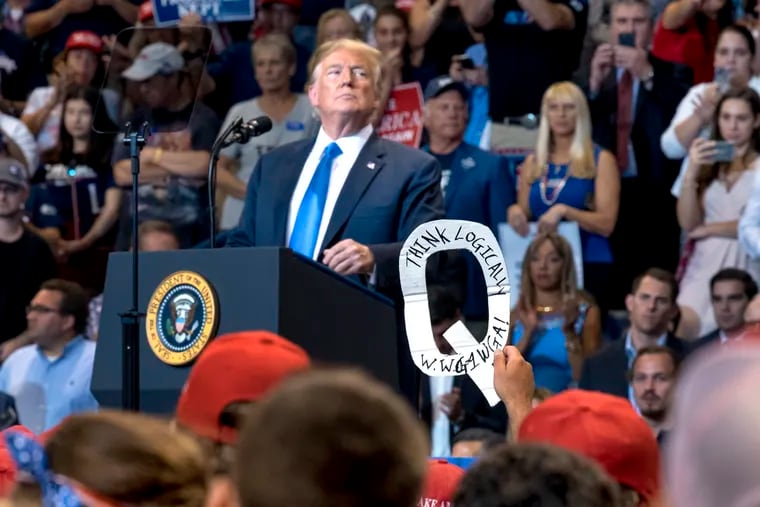 Q Anon supporters are in the crowd as President Trump appears at a campaign rally  for U.S. Rep. Lou Barletta at the Mohegan Sun Arena in Wilkes-Barre August 2, 2018.