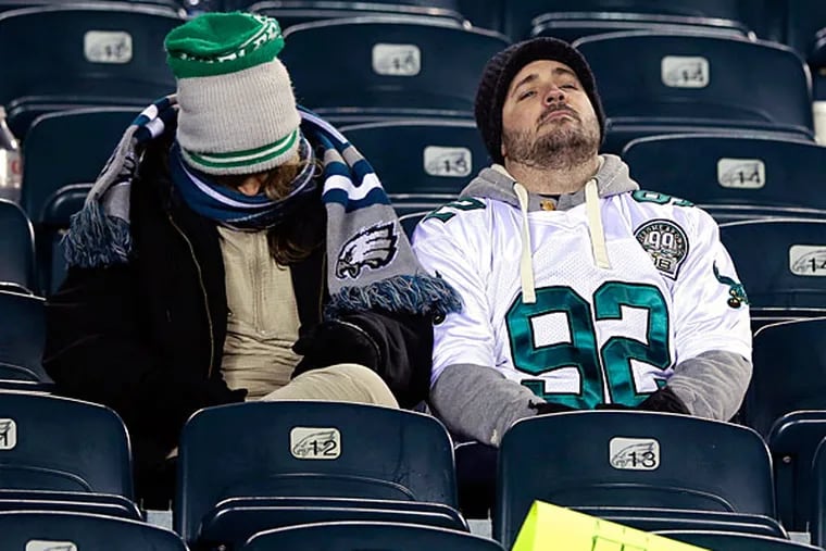 Eagles fans sit in the stands after the Eagles lost an NFL wild-card playoff football game to the New Orleans Saints, 26-24, Saturday, Jan. 4, 2014, in Philadelphia. (Michael Perez/AP file)