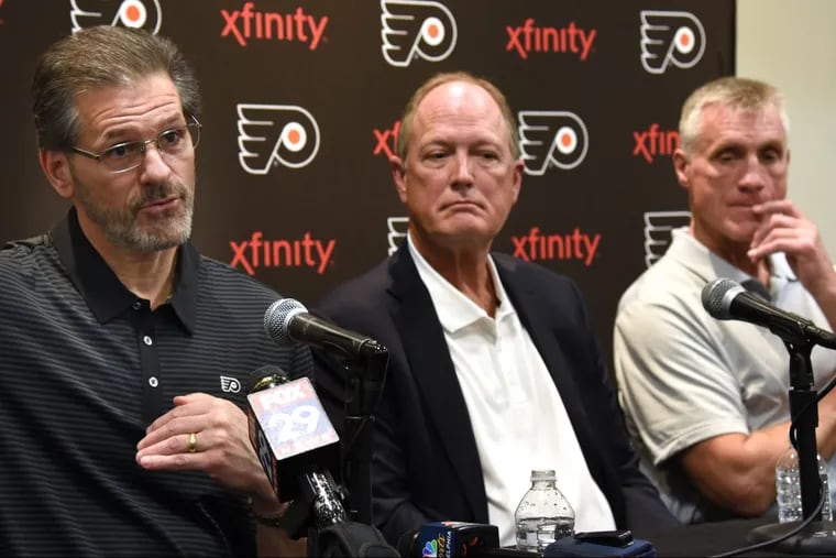 Paul Holmgren (right), the Flyers’ president, says GM Ron Hextall will have “free rein” to spend as he sees fit in free agency. In the middle is Dave Scott, the Comcast Spectacor president and CEO, in a photo from earlier in the season.