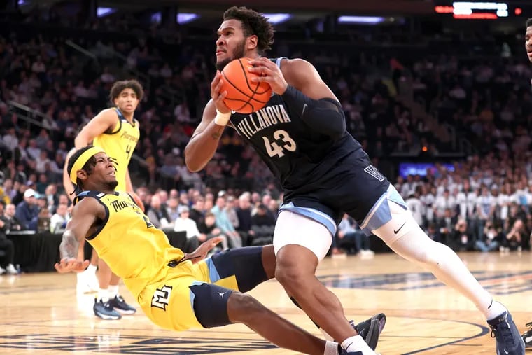 Villanova's Eric Dixon, right, gets fouled by Marquette's Chase Ross as he drives to the basket during the Wildcats' quarterfinal game loss in the Big East Tournament on Thursday.