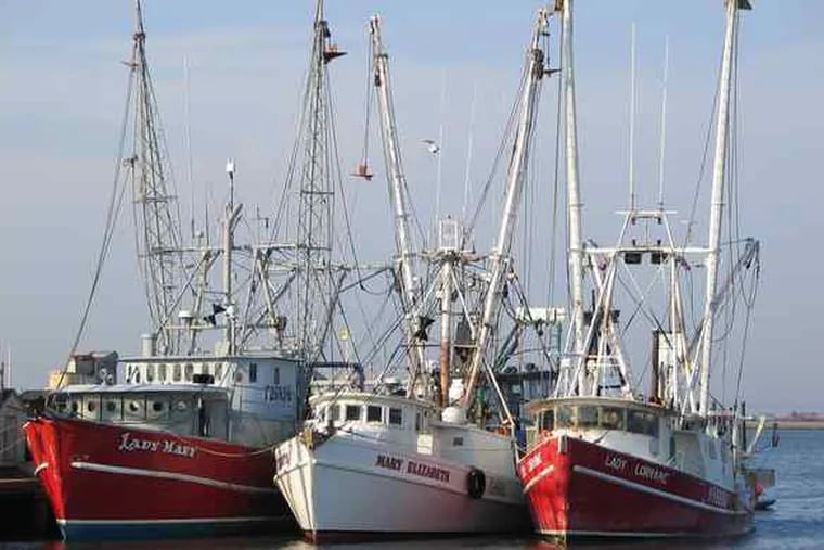 The Lady Mary (left) moored in Cape May Harbor on May 12, 2004. The scallop boat sank on March 24, 2009, killing six crew members.
