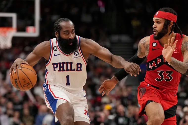 Philadelphia 76ers guard James Harden (1) protects the ball from Toronto Raptors guard Gary Trent Jr. (33) during the second half on Oct. 26, 2022 in Toronto. (Frank Gunn/The Canadian Press via AP)