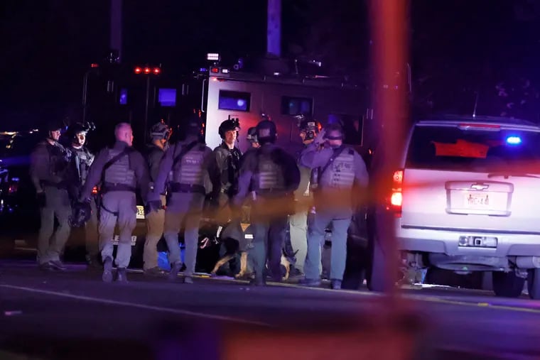 Members of the New Jersey State Police F.A.S.T. Team at the scene of a multiple shooting on East Commerce Street in Fairfield Township, Cumberland County, shortly before midnight Saturday. A man and a woman were killed and 12 other adults were injured, police said.