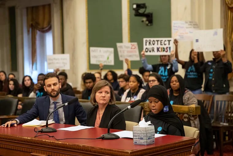 Deaziah Wilson, right, speaks during a hearing on restricting the sales of e-cigarettes at City Hall in Philadelphia on Wednesday, Nov. 20, 2019.