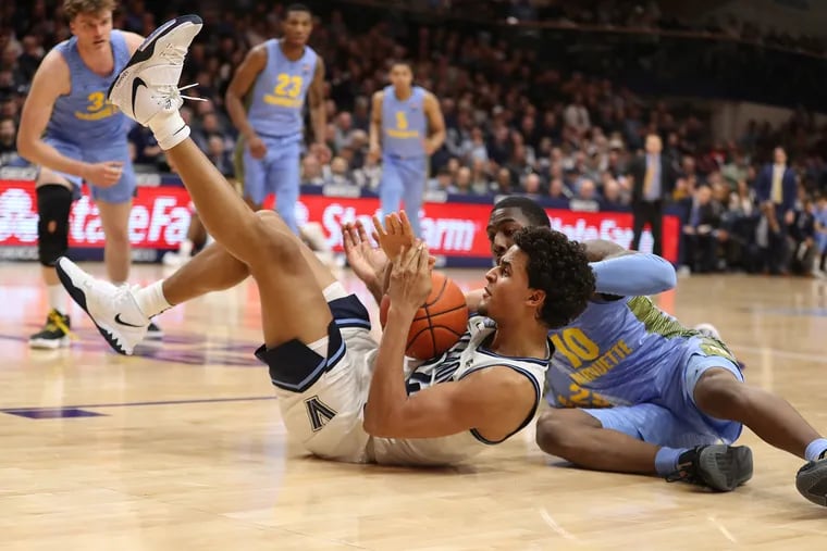 Jeremiah Robinson-Earl, left, of Villanova beats Symir Torrence of Marquette  to a loose ball during the second half on Feb. 12.