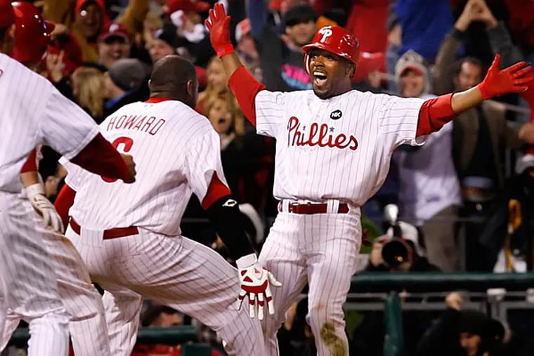 Jimmy Rollins celebrates his game winning hit with Ryan Howard on
Monday, October 19, 2009. (Ron Cortes/Staff Photographer)
