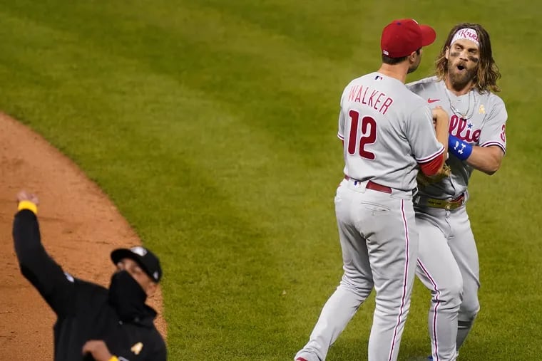 Bryce Harper, right, was ejected by umpire Roberto Ortiz, left, in the fifth inning of the Phillies' 5-1 loss to the Mets Saturday night for arguing a foul call.