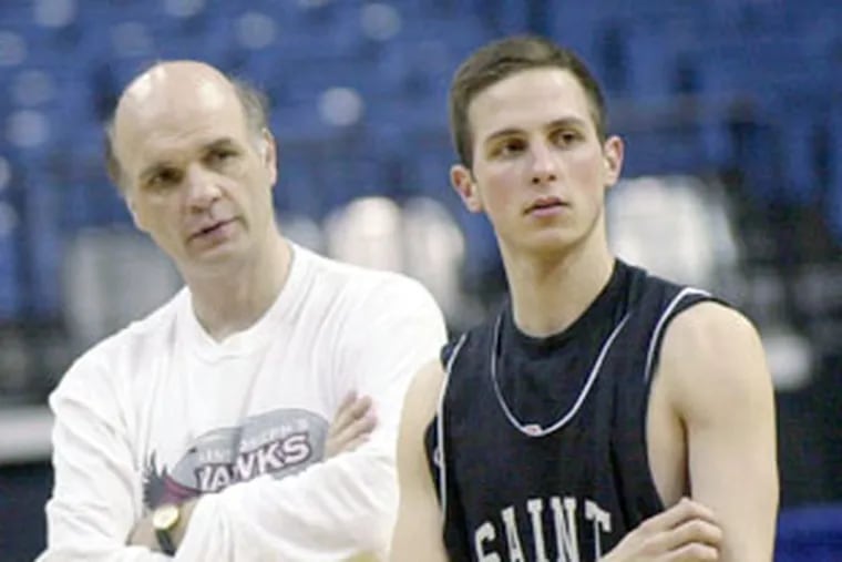 Phil Martelli, left, talks to his son Phil Martelli Jr., at a 2003 practice.